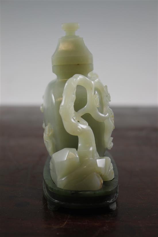 A Chinese pale celadon jade vase and cover, with spinach green jade stand, Qing dynasty or later, 4.3cm., width 13.5cm., fitted rosewoo